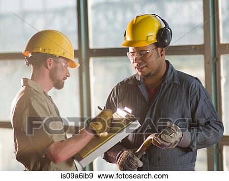 Stock Photo - Engineers talking on construction site. Fotosearch