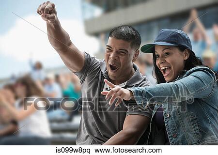 Stock Photography - Excited couple at sports game. Fotosearch