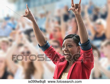 Excited woman in crowd, making hand gesture View Large Photo Image Stock Photo - Excited woman in crowd, making hand gesture. Fotosearch