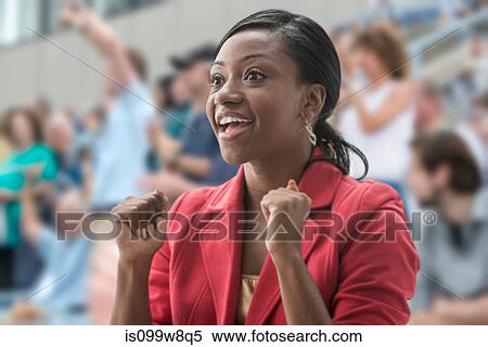 Stock Photography - Excited woman in crowd. Fotosearch