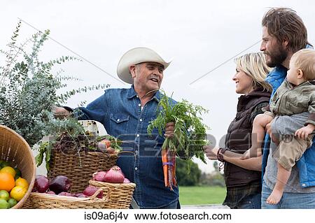 Stock Photo - Family shopping at farmer's market. Fotosearch