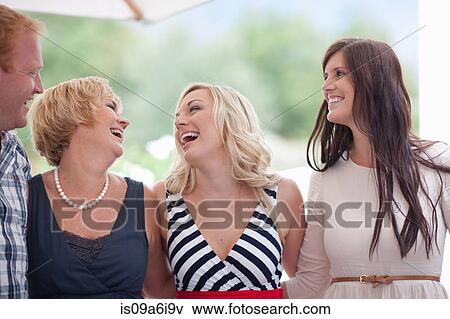 Stock Photo - Family smiling together outdoors. Fotosearch