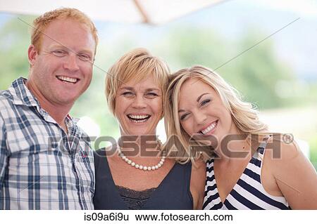 Stock Photograph - Family smiling together outdoors. Fotosearch