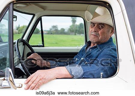Stock Image - Farmer driving truck. Fotosearch