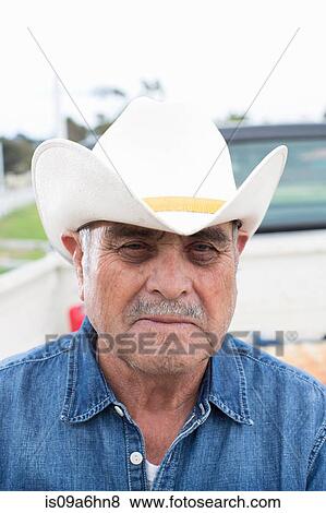 Farmer wearing cowboy hat outdoors View Large Photo Image Stock Photo - Farmer wearing cowboy hat outdoors. Fotosearch