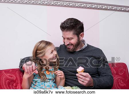 Father and daughter eating cupcakes View Large Photo Image Stock Photo - Father and daughter eating cupcakes. Fotosearch