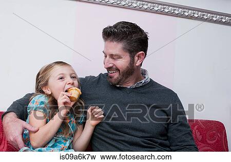 Father and daughter eating cupcakes View Large Photo Image Stock Photo - Father and daughter eating cupcakes. Fotosearch
