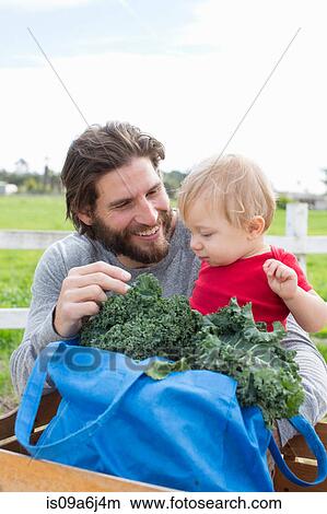 Picture - Father and son at farmer's market. Fotosearch