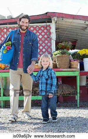 Stock Photo - Father and son at farmer's market. Fotosearch