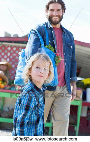 Father and son at farmer's market View Large Photo Image Stock Photo - Father and son at farmer's market. Fotosearch