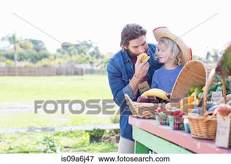 Father and son at farmer's market View Large Photo Image Stock Photo - Father and son at farmer's market. Fotosearch