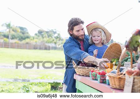 Stock Photo - Father and son at farmer's market. Fotosearch