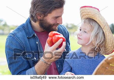 Stock Photo - Father and son at farmer's market. Fotosearch