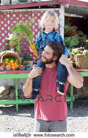 Stock Photography - Father and son at farmer's market. Fotosearch