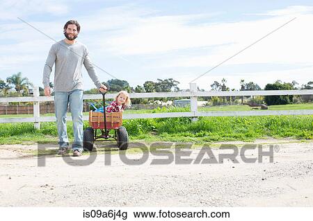 Father pulling son in wagon View Large Photo Image Stock Image - Father pulling son in wagon. Fotosearch