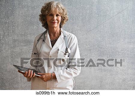 Stock Image - Female doctor holding digital tablet. Fotosearch
