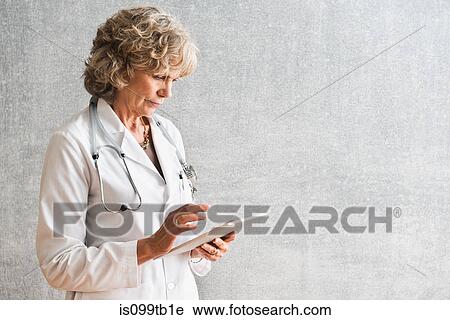 Female doctor using at digital tablet View Large Photo Image Stock Image - Female doctor using at digital tablet. Fotosearch