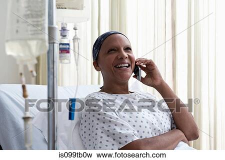 Stock Photo - Female hospital patient using cellphone. Fotosearch