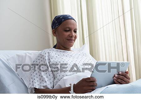 Female hospital patient using digital tablet View Large Photo Image Stock Photo - Female hospital patient using digital tablet. Fotosearch
