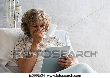 Female hospital patient with digital tablet, laughing View Large Photo Image Picture - Female hospital patient with digital tablet, laughing. Fotosearch