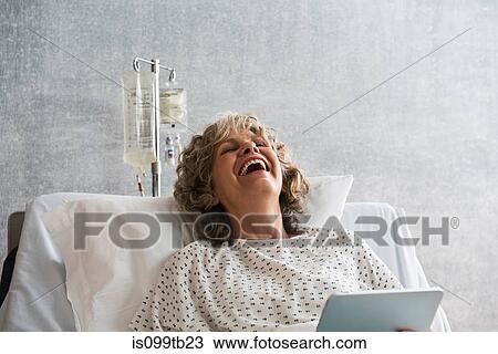 Female hospital patient with digital tablet, laughing View Large Photo Image Stock Image - Female hospital patient with digital tablet, laughing. Fotosearch
