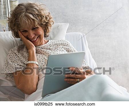 Female hospital patient with digital tablet, smiling View Large Photo Image Stock Photography - Female hospital patient with digital tablet, smiling. Fotosearch