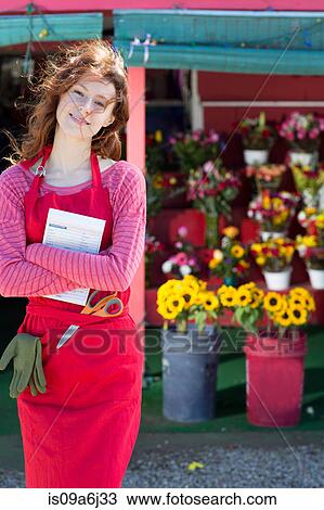 Stock Image - Florist holding notebook in shop. Fotosearch