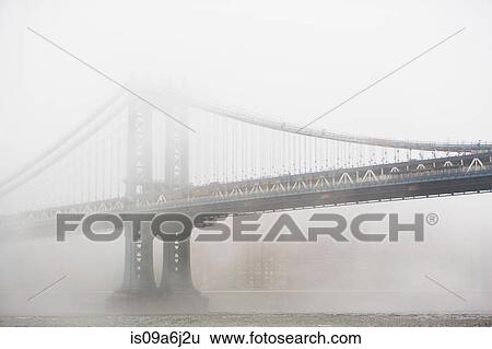 Stock Photograph - Fog rolling over bridge. Fotosearch