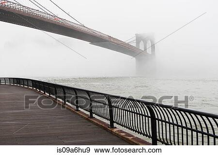 Stock Photo - Fog rolling over Brooklyn bridge. Fotosearch
