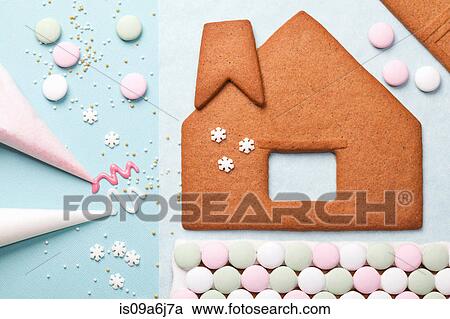 Stock Image - Gingerbread house components on table. Fotosearch