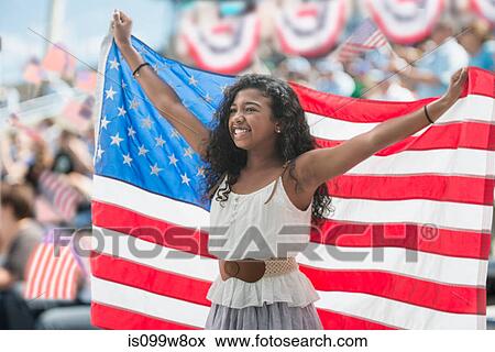 Stock Photo - Girl at rally holding up american flag. Fotosearch