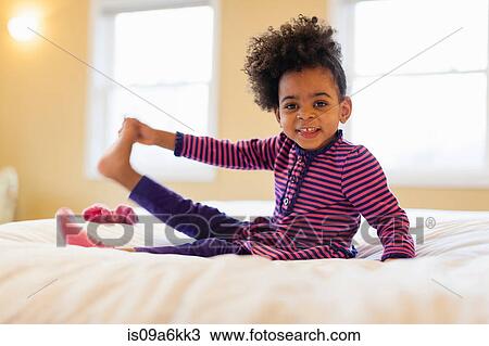 Girl playing on bed View Large Photo Image Stock Image - Girl playing on bed. Fotosearch