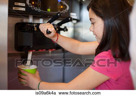 Girl pouring cup of frozen yogurt View Large Photo Image Stock Image - Girl pouring cup of frozen yogurt. Fotosearch