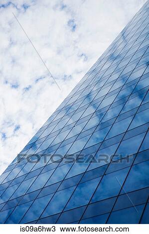 Glass skyscraper and cloudy sky View Large Photo Image Stock Image - Glass skyscraper and cloudy sky. Fotosearch