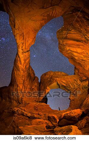 Hiker and night sky from Double Arch View Large Photo Image Stock Photo - Hiker and night sky from Double Arch. Fotosearch