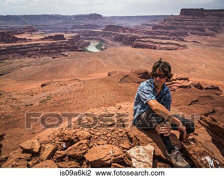 Stock Image - Hiker sitting on Pyramid Butte summit. Fotosearch