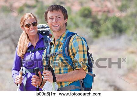 Picture - Hikers smiling in rural landscape. Fotosearch