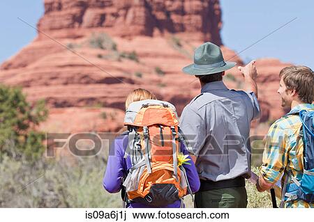 Stock Image - Hikers talking to park ranger. Fotosearch