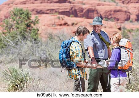 Hikers talking to park ranger View Large Photo Image Stock Image - Hikers talking to park ranger. Fotosearch