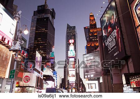 Stock Image - Illuminated billboards in Times Square. Fotosearch