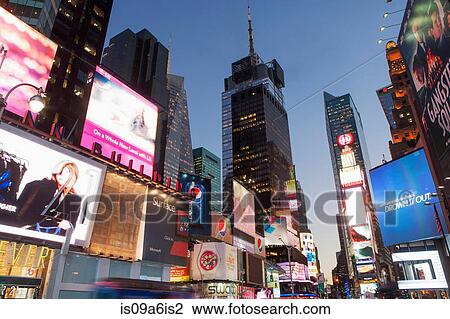 Stock Image - Illuminated billboards in Times Square. Fotosearch