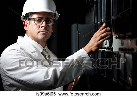 Stock Photography - Industrial worker at switch board. Fotosearch