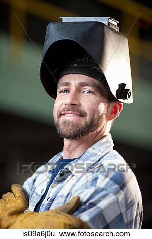 Stock Photograph - Industrial worker smiling in plant. Fotosearch