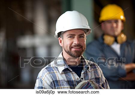 Stock Photography - Industrial worker smiling in plant. Fotosearch