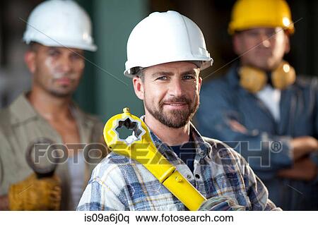 Stock Photography - Industrial worker smiling in plant. Fotosearch