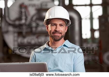 Industrial worker using laptop View Large Photo Image Stock Image - Industrial worker using laptop. Fotosearch