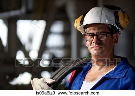 Industrial worker with wires in plant View Large Photo Image Stock Image - Industrial worker with wires in plant. Fotosearch