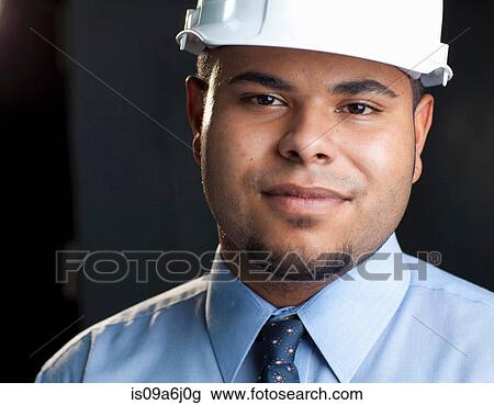 Stock Image - Industrial worker's smiling face. Fotosearch