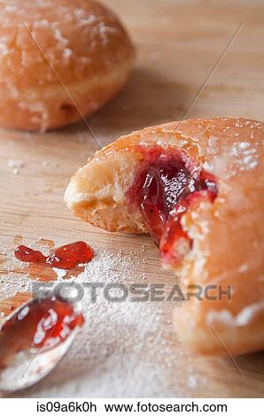 Jam doughnut on table View Large Photo Image Stock Image - Jam doughnut on table. Fotosearch