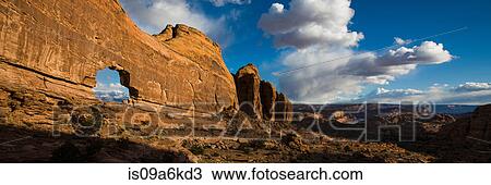 Stock Image - Jeep Arch in desert rock formations. Fotosearch
